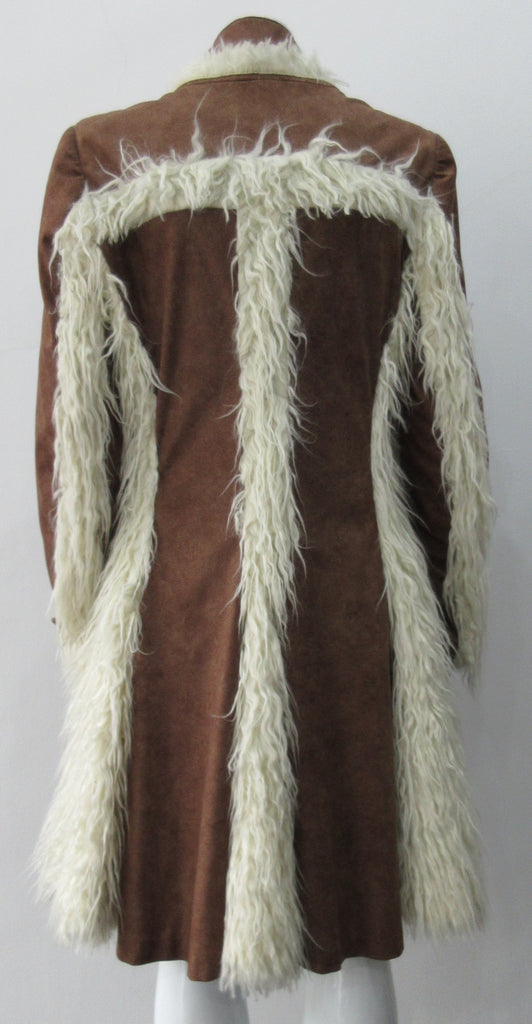 Split Suede Coat. Faux suede coat with faux fur contrast trim on lapels and inside. Flared towards hem with contrast faux fur panels. Rich saddle lighter brown colour. Feminine version inspired from 18th century men's evening coat. Multiple ways of buttoning as illustrated. Can be paired with 060301 Brown Suede Trouser. Formerly a showpiece, specially made. No Label. CB Length 94cm. Sleeve length from side shoulder point 75cm. 850g approximate weight. 95% Polyester, 5% Rayon. Contrast: 100% Viscose. Dry Cl