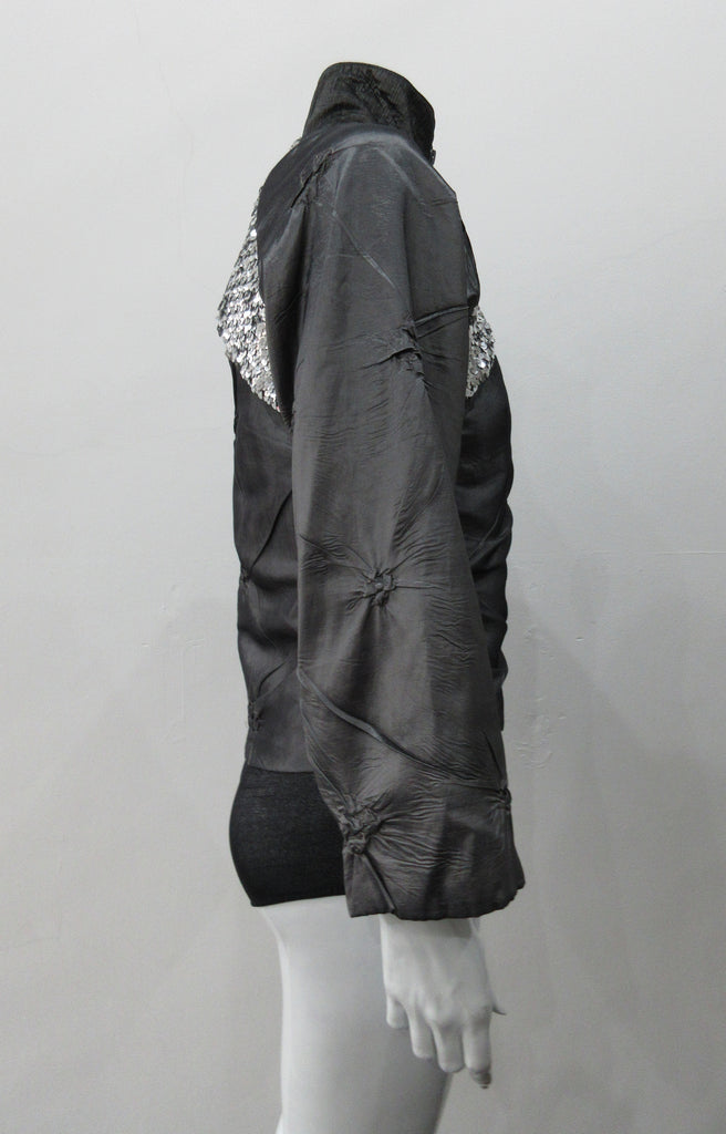 Grey Sparkle Raglan Panel Zip Jacket. Featuring pinched satin fabric and brilliant sequin panel on both front and back sides. CF zipper and 8cm high contrast collar. CB length 56cm. Sleeve length from side neck point 66cm. 220g approximate weight. 60% Polyester, 30% Viscose, 10% Nylon. Lining: 100% Rayon. Dry Clean Only. Made in Canada