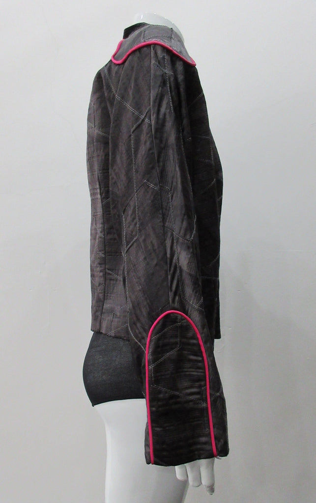 Side Zip Jacket. Assymetrical side front zip jacket featuring abstract stitching incorporated into the fabric for a geometric feel. Rich deep grey colour with pink piping accents on shoulder and sleeve panels. Fully lined. CB length 53cm. Sleeve length from side neck point 75cm. 400g approximate weight. 29% Nylon, 22% Viscose, 28% Cotton, 12% Linen, 2% Polyester. Lining: 100% Rayon. Dry Clean Only. Made in Canada