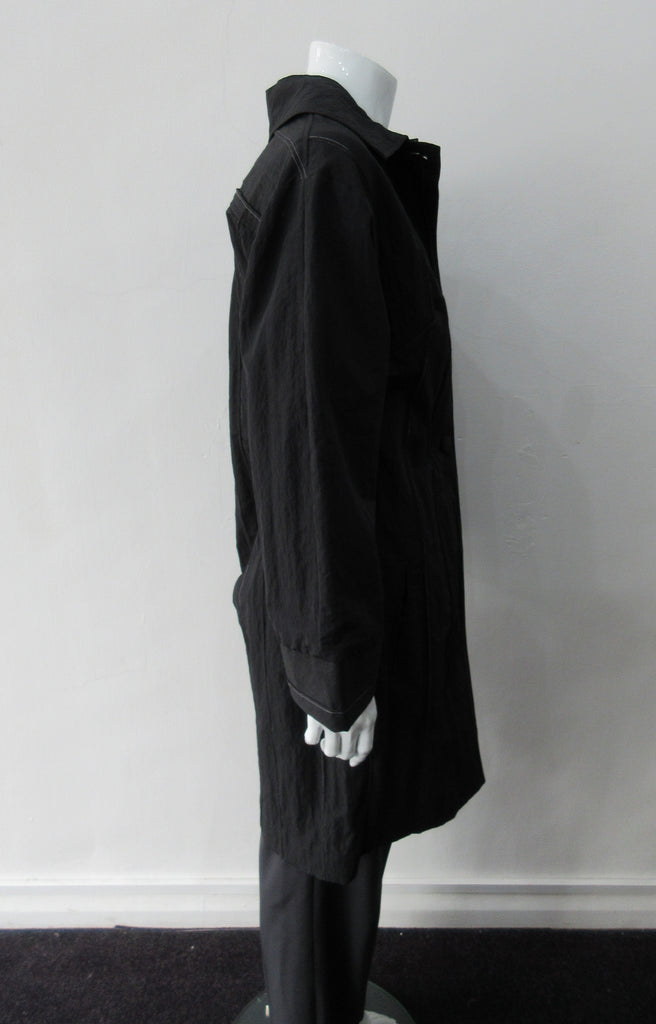 Pinched fabric Coat with white stitching creating striped effect. CB pleat for greater ease. Large covered buttons and front welt pockets. CB Length 94cm, 62% Nylon, 36% Cotton, 2% Polyester, Lining: 100% Rayon, Made in Canada