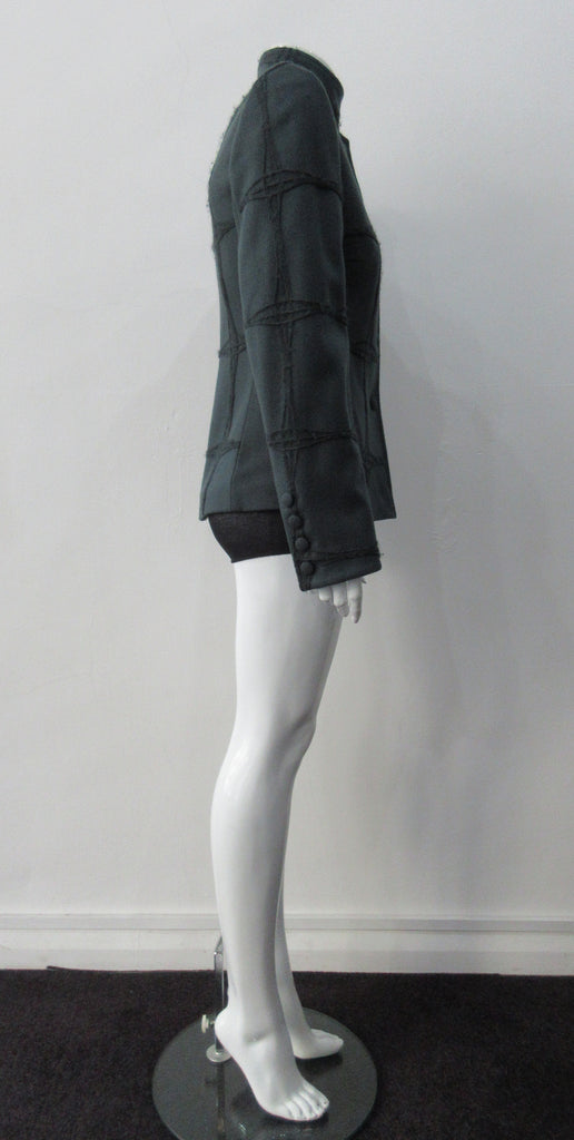 Wobbler Jacket. Tailored jacket with button collar and covered buttons in deep taupe grey, with a slight military feel. Features neo-classical trim design which naturally becomes fuzzy over time as a design detail. Size 8