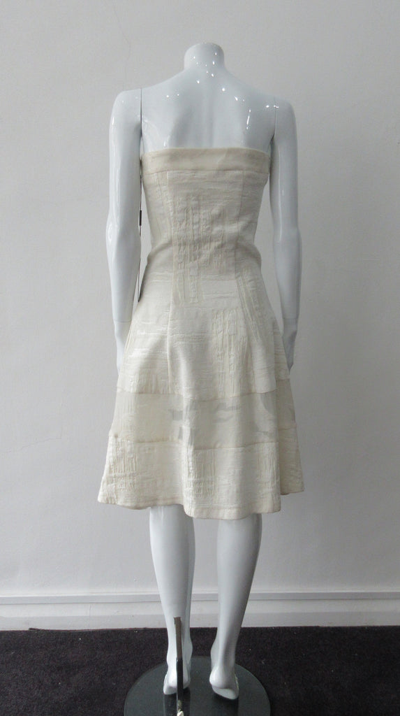 Multi corded velvet and floral trimmed off white dress with top panel for comfortable fit. Flattering slight swing below the waist for bit of ease. Size 8 CB Length 93cm 450g approximate weight 62% Viscose, 20% Wool, 15% Silk, 3% Cotton Contrast: 38% Nylon, 26% Wool, 20% Cotton, 16% Viscose Dry Clean Only Made in Croatia