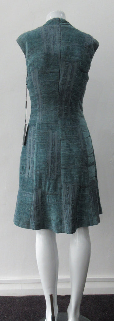 Round Seam Dress. Dark sea green textured dress with curved neck panels. With CB zipper. CB length 93cm. 82% Wool, 18% Nylon. Lining: 100% Rayon. Dry Clean Only, Made in Croatia
