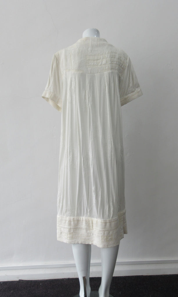 Half Pleat Dress: Art-Nouveau style with pleats to add fullness into tapered hem. Invisible zipper on shoulder. Falls mid calf Size 8. CB Length 105cm, 350g approximate weight. 62% Viscose, 20% Wool, 15 %Silk, 3% Cotton Contrast: 46% Modal, 34% Nylon, 10% Angora, 10% Viscose, Dry Clean Only, Made in Croatia