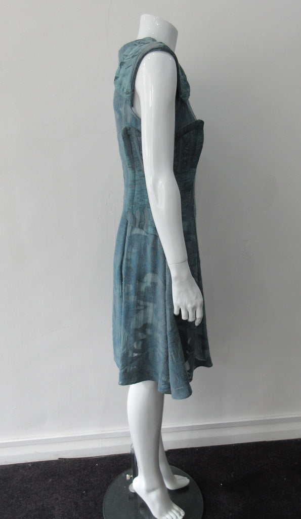 Trenched Swing Dresss. Dark sea green textured dress with trenchcoat-style panels. With CB zipper. CB length 92cm. 600g approximate weight. 37% Nylon, 25% Wool, 20% Cotton, 15% Viscose, 3% Silk. Dry Clean Only, Made in Croatia