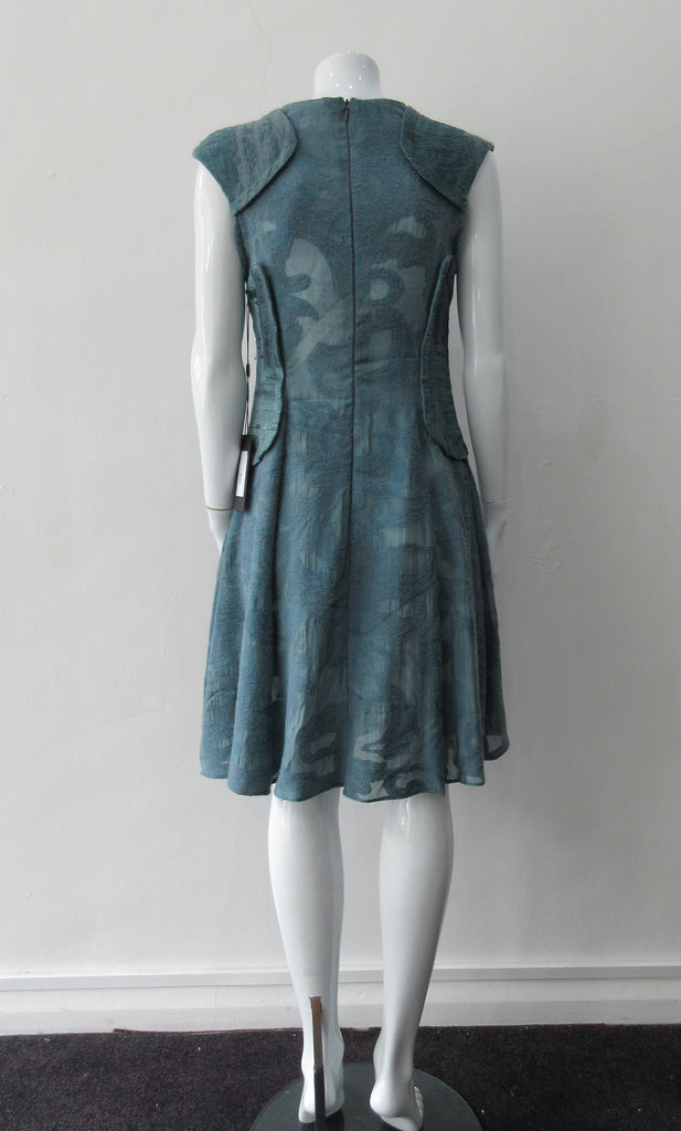 Trenched Swing Dresss. Dark sea green textured dress with trenchcoat-style panels. With CB zipper. CB length 92cm. 600g approximate weight. 37% Nylon, 25% Wool, 20% Cotton, 15% Viscose, 3% Silk. Dry Clean Only, Made in Croatia