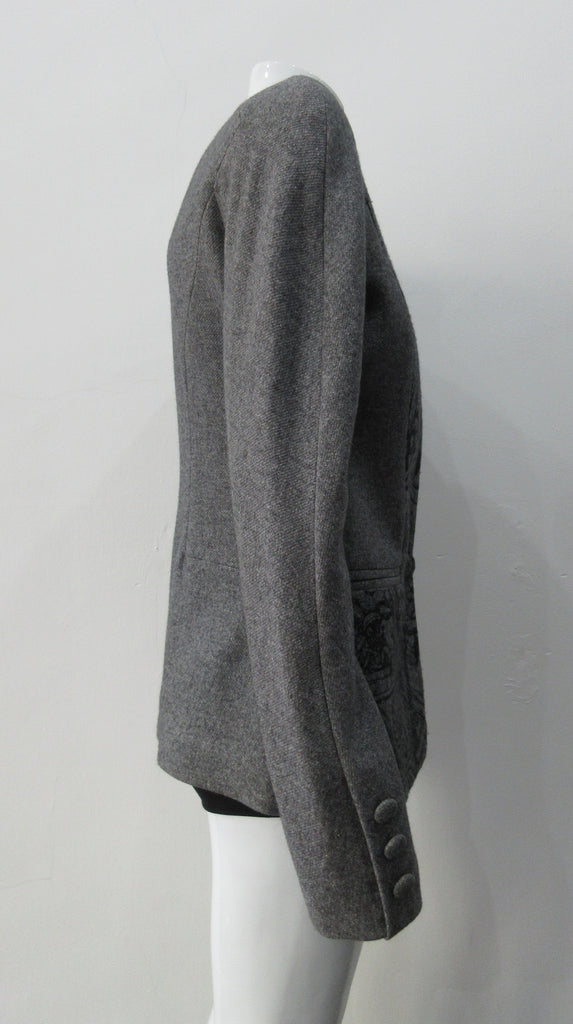 False Peak Jacket. Old-School Jacket in charcoal grey with rounded shoulders. Design features sewn in collar and lapel. Covered buttons throughout. Relaxed fit. Size 8