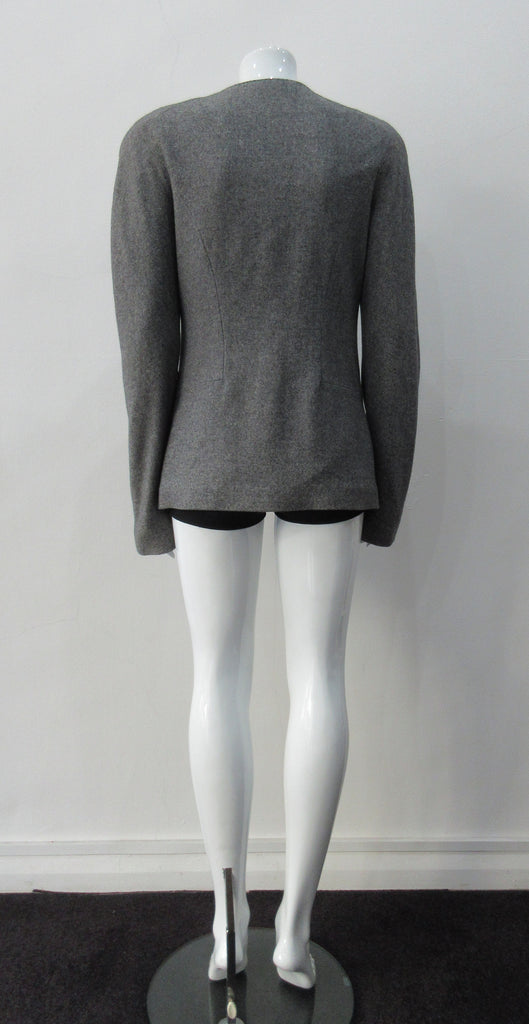 False Peak Jacket. Old-School Jacket in charcoal grey with rounded shoulders. Design features sewn in collar and lapel. Covered buttons throughout. Relaxed fit. Size 8