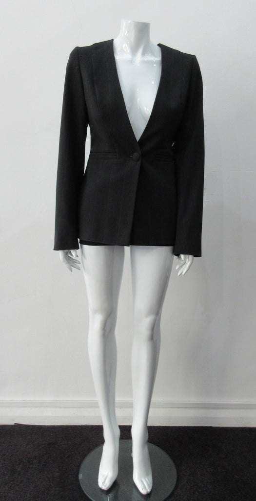 Collarless jacket featuring faux collar details with an overall tailored feel, in dark greyish brown colour. Fabric has very fine stripes. Covered buttons throughout with 1 button CF closure.