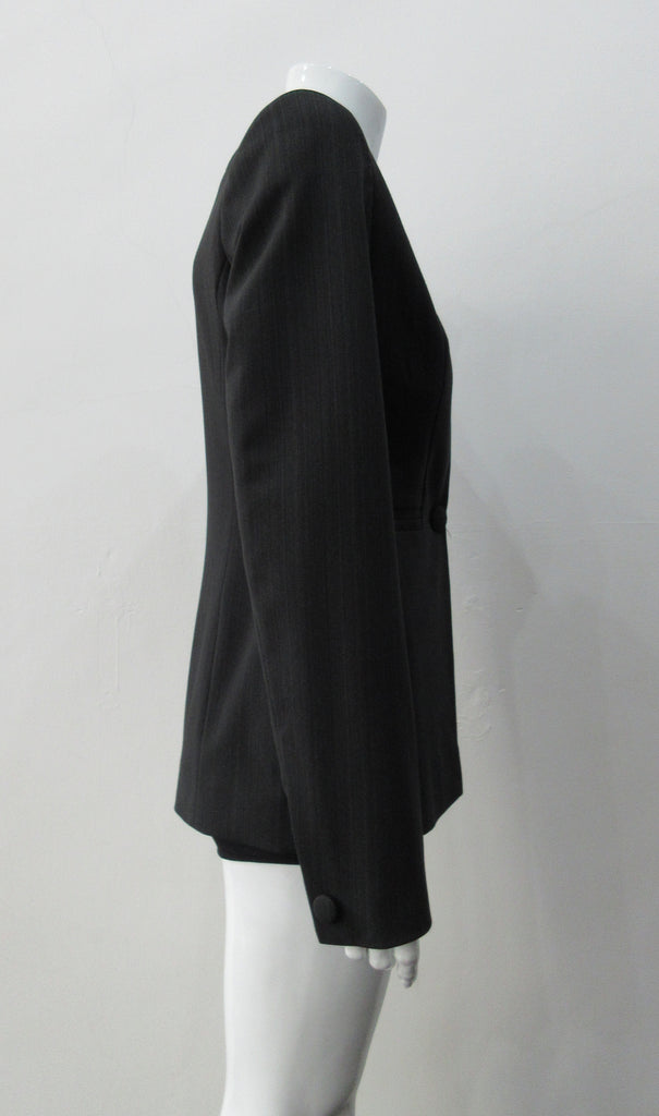 Collarless jacket featuring faux collar details with an overall tailored feel, in dark greyish brown colour. Fabric has very fine stripes. Covered buttons throughout with 1 button CF closure.