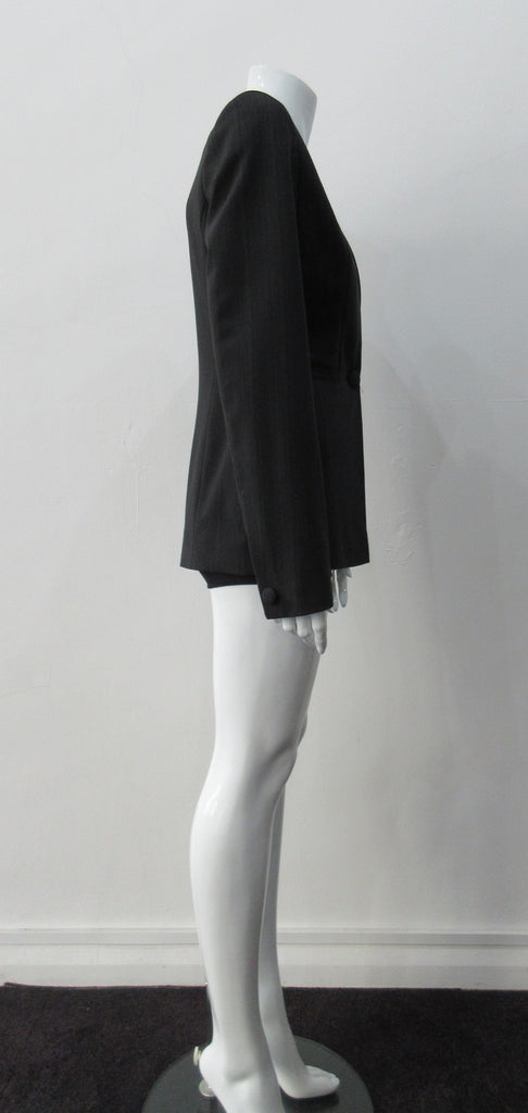 Collarless jacket featuring faux collar details with an overall tailored feel, in dark greyish brown colour. Fabric has very fine stripes. Covered buttons throughout with 1 button CF closure.