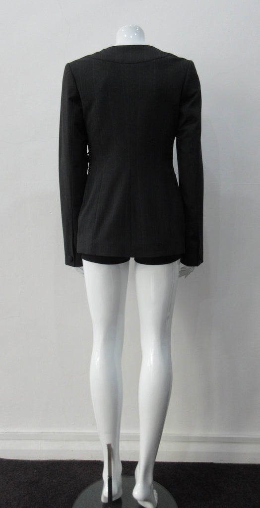 Collarless jacket featuring faux collar details with an overall tailored feel, in dark greyish brown colour. Fabric has very fine stripes. Covered buttons throughout with 1 button CF closure.