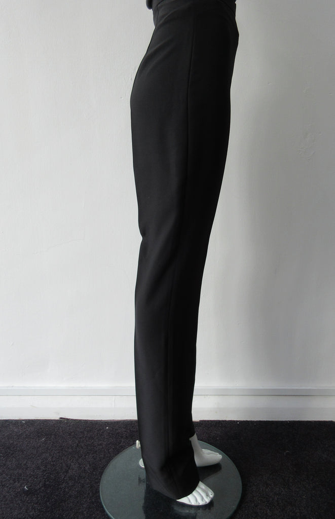 Higher waisted black trouer with tight waist and tapered hems. Contrast print inside waistband. 100% Poyester Crepe Contrast: 100% Silk Dry Clean Only. Exceptional tight fit with small raised waist, more suitable for a very slender figure. Size 6 or XS, Inseam 88cm