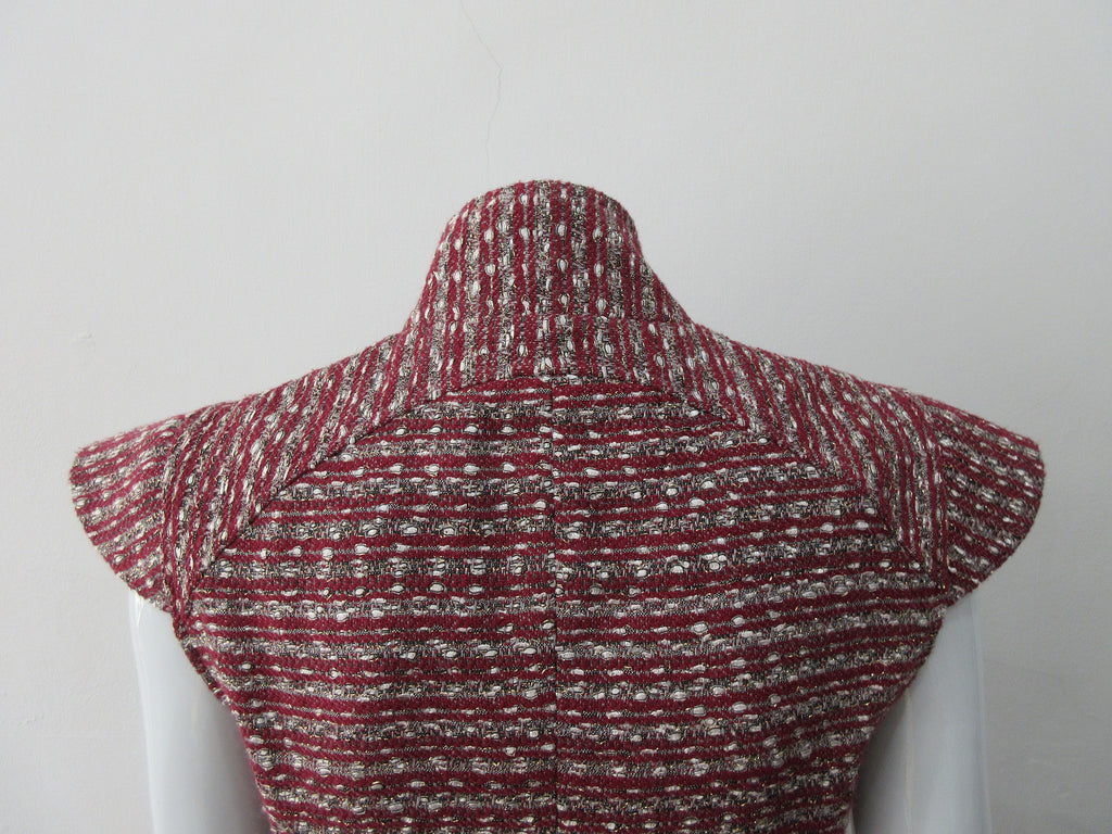 Sleeveless Jacket, Mid-Crop red & grey weave with extended cap at shoulder point for faux sleeve top. Matches with 110701 Yoke Skirt. CB Length 49cm. 450g approximate weight. Size 8. 45% Cotton, 35% Nylon, 15% Polyester, 5% Viscose Lining: 100% Rayon Dry Clean Only. Made in Canada