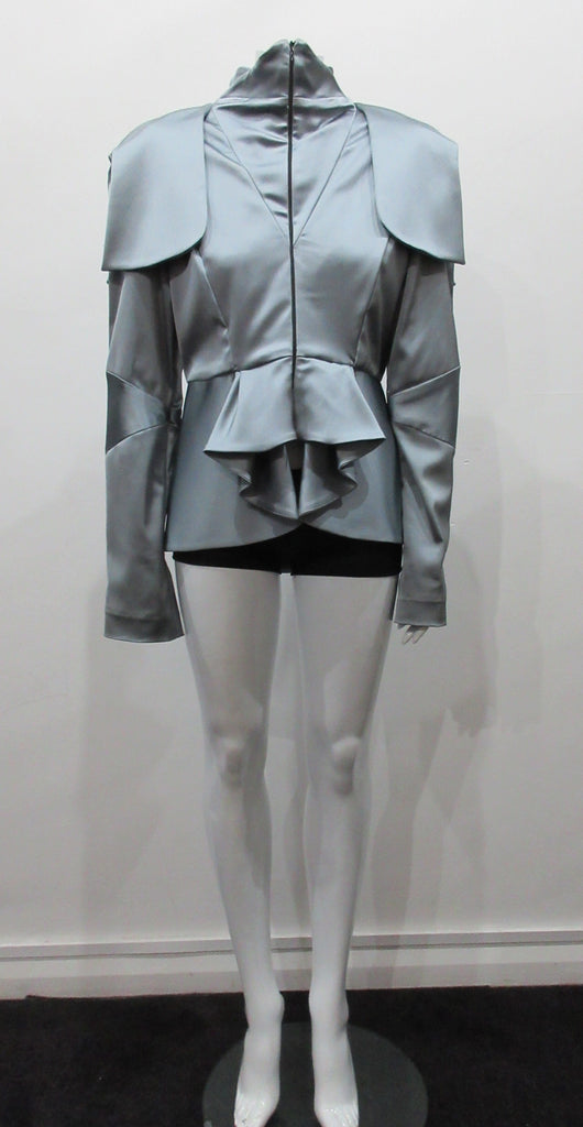 Grey-Blue flap panel short jacket, with pleated peplum. Heavier weight fabric ideal for colder weather wear. CF and sleeve hem zippers.