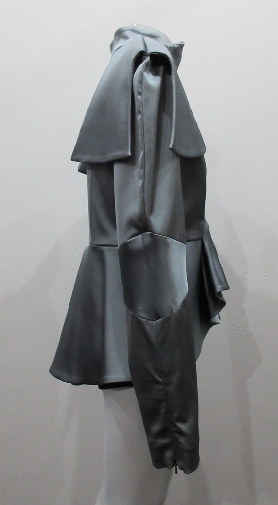 Grey-Blue flap panel short jacket, with pleated peplum. Heavier weight fabric ideal for colder weather wear. CF and sleeve hem zippers.