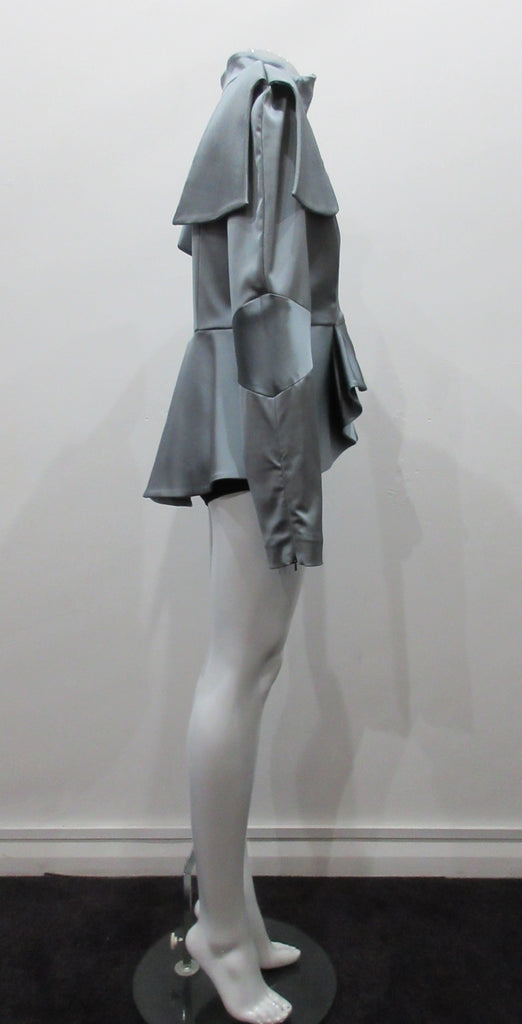 Grey-Blue flap panel short jacket, with pleated peplum. Heavier weight fabric ideal for colder weather wear. CF and sleeve hem zippers.