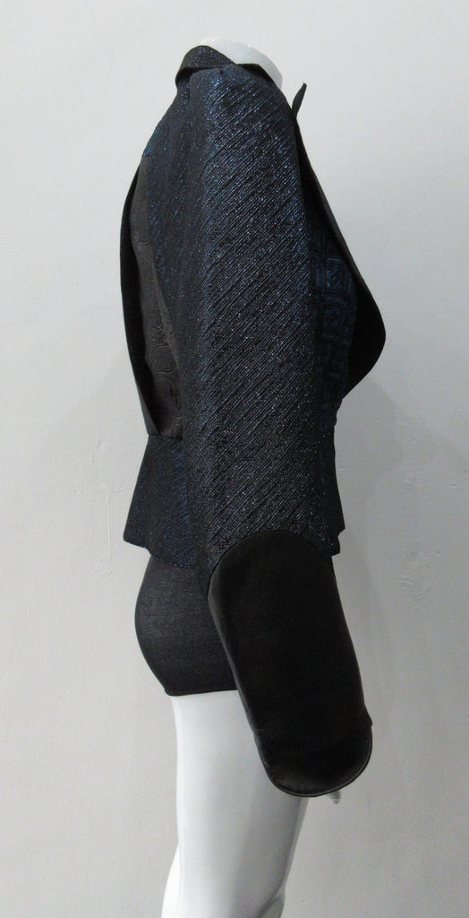 Romanov Crop Jacket. Cropped big lapelled jacket in electric deep blue combination of fabrics & textures. Featuring CF clip at waist. Leather cuffed sleeve hems. CB length 52cm. 200g approximate weight. 59% Cotton, 41% Nylon. Contrast: 41% Viscose, 37% Acrylic, 22% Nylon. Lining: 100% Rayon. Dry Clean Only. Made in England