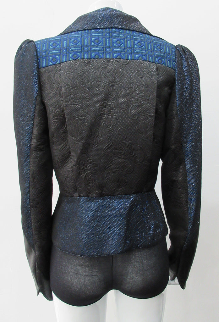 Romanov Crop Jacket. Cropped big lapelled jacket in electric deep blue combination of fabrics & textures. Featuring CF clip at waist. Leather cuffed sleeve hems. CB length 52cm. 200g approximate weight. 59% Cotton, 41% Nylon. Contrast: 41% Viscose, 37% Acrylic, 22% Nylon. Lining: 100% Rayon. Dry Clean Only. Made in England