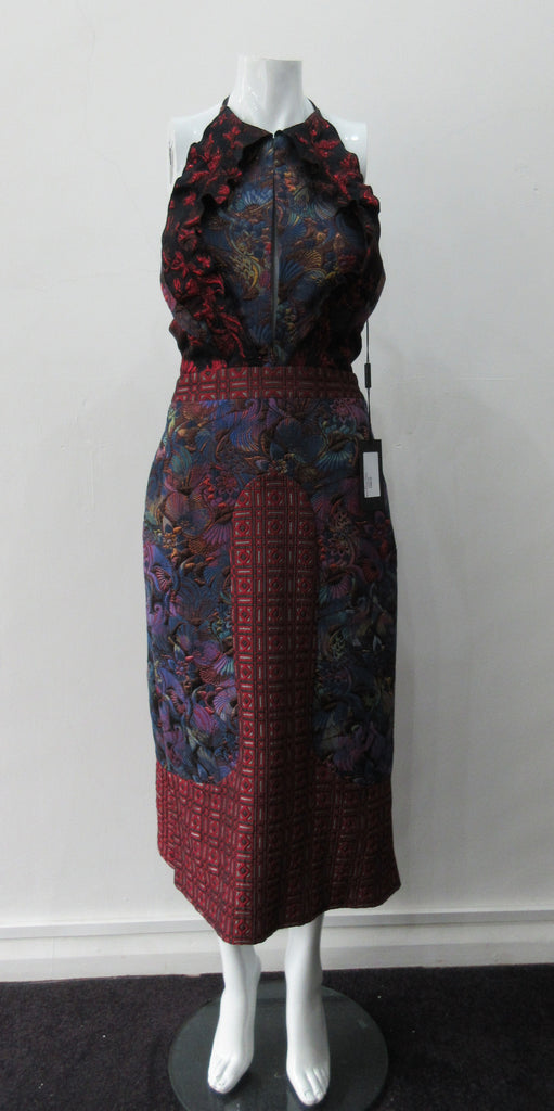 Dark Sleevelss Slit Dress. Extreme cutaway CF slit dress with tie-neck. Low cut away back with invisible zipper. Covers side bust and frills on side fronts. CF Dress length from neckpoint 110cm. 350g approximate weight. 65% Cotton, 35% Polyester. Contrast: 56% Polyester, 36% Acetate, 8% Polyamide. Lining: 100% Rayon. Dry Clean Only. Made in England