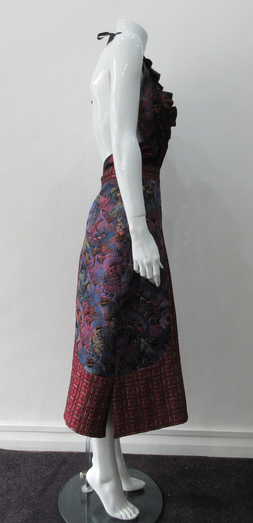 Dark Sleevelss Slit Dress. Extreme cutaway CF slit dress with tie-neck. Low cut away back with invisible zipper. Covers side bust and frills on side fronts. CF Dress length from neckpoint 110cm. 350g approximate weight. 65% Cotton, 35% Polyester. Contrast: 56% Polyester, 36% Acetate, 8% Polyamide. Lining: 100% Rayon. Dry Clean Only. Made in England