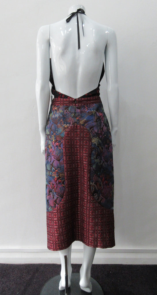 Dark Sleevelss Slit Dress. Extreme cutaway CF slit dress with tie-neck. Low cut away back with invisible zipper. Covers side bust and frills on side fronts. CF Dress length from neckpoint 110cm. 350g approximate weight. 65% Cotton, 35% Polyester. Contrast: 56% Polyester, 36% Acetate, 8% Polyamide. Lining: 100% Rayon. Dry Clean Only. Made in England