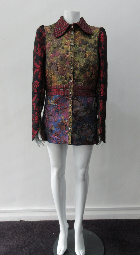 Collared Top Multi-Combined textured fabric in brass, purlple brocade and red floral for sleeves. CF buttons in shiny quartz-like glass and large Peter Pan style collar CB jacket length 71cm 250g approximate weight 65% Cotton, 35% Polyester Contrast: 60% Acetate, 28% Polyester, 12% Polyamide Dry Clean Only. Made in England