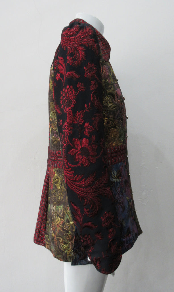 Collared Top Multi-Combined textured fabric in brass, purlple brocade and red floral for sleeves. CF buttons in shiny quartz-like glass and large Peter Pan style collar CB jacket length 71cm 250g approximate weight 65% Cotton, 35% Polyester Contrast: 60% Acetate, 28% Polyester, 12% Polyamide Dry Clean Only. Made in England