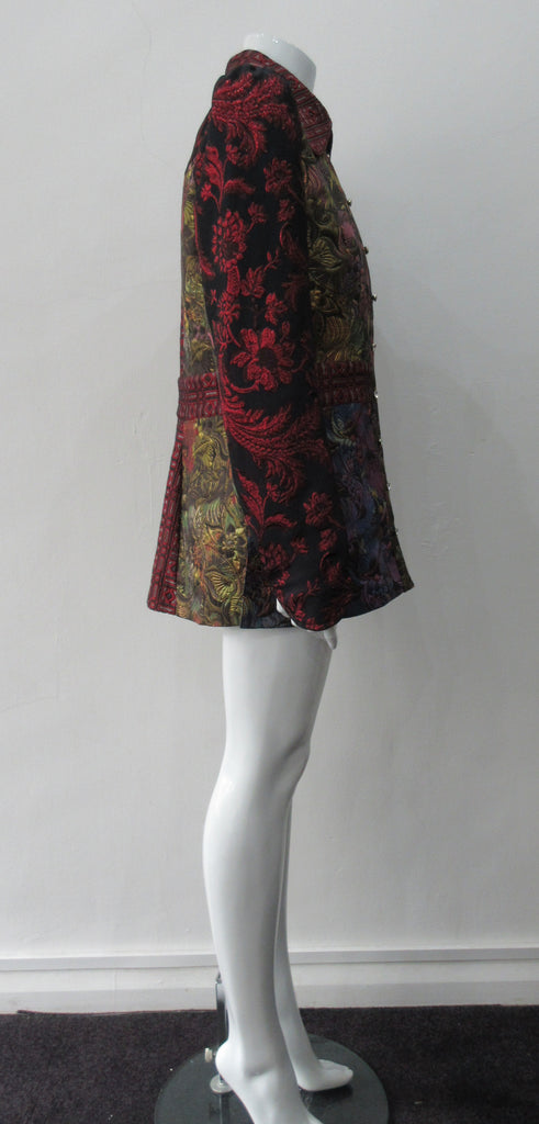 Collared Top Multi-Combined textured fabric in brass, purlple brocade and red floral for sleeves. CF buttons in shiny quartz-like glass and large Peter Pan style collar CB jacket length 71cm 250g approximate weight 65% Cotton, 35% Polyester Contrast: 60% Acetate, 28% Polyester, 12% Polyamide Dry Clean Only. Made in England