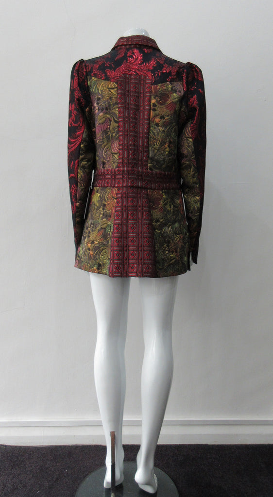 Collared Top Multi-Combined textured fabric in brass, purlple brocade and red floral for sleeves. CF buttons in shiny quartz-like glass and large Peter Pan style collar CB jacket length 71cm 250g approximate weight 65% Cotton, 35% Polyester Contrast: 60% Acetate, 28% Polyester, 12% Polyamide Dry Clean Only. Made in England