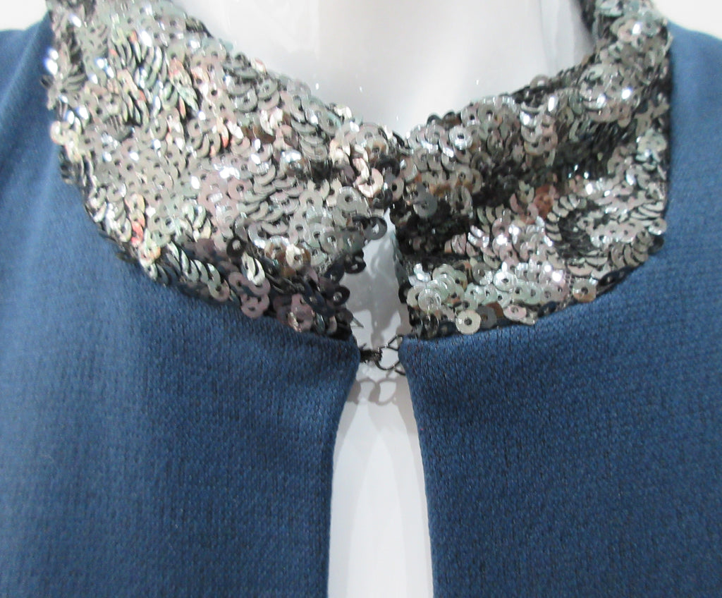 Zoom Dress. Cut away dark blue sleevelss dress featurung geometric panels in stretch jersey and multi-coloured textured hexagon design. CF seperation gap with 4cm high silver sequined collar. Silver piping across front of dress. Shorter version of 170610L Zoom Dress. CB Dress Length from neck point 108cm. 450g approximate weight. 81% Polyester, 19% Polyamide Contrast: 80% Silk, 17% Polyamide, 3% Elastine. Lining: 100% Viscose. Dry Clean. Only Made in England