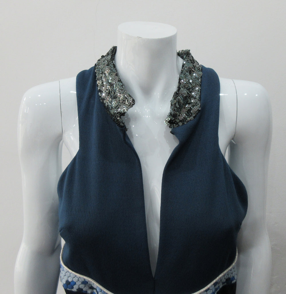 Zoom Dress. Cut away dark blue sleevelss dress featurung geometric panels in stretch jersey and multi-coloured textured hexagon design. CF seperation gap with 4cm high silver sequined collar. Silver piping across front of dress. Shorter version of 170610L Zoom Dress. CB Dress Length from neck point 108cm. 450g approximate weight. 81% Polyester, 19% Polyamide Contrast: 80% Silk, 17% Polyamide, 3% Elastine. Lining: 100% Viscose. Dry Clean. Only Made in England