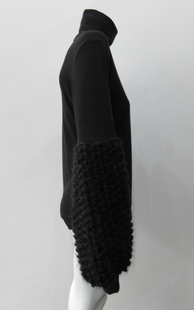 Fluffy Sleeve Top. Extremely soft Cotton/Lycra knit top with 11.5cm high collar. Soft curly sleeve contrast below elbow to cuffs. CB length from neckpoint 64cm. 210g approximate weight. 96% Cotton, 2% Lycra. Contrast 100% Viscose. Dry Clean Only. Made in Canada