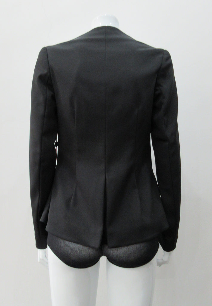 Dark Corset Jacket. Geometric cut lower front metal zip jacket with flared peplum-style hem in medium length. Designed for a tighter fit around the bust area. In solid black with slight stretch. CB length 63cm. Sleeve length from side neck point 78cm. 750g approximate weight. 95% Polyester, 5% Spandex Lining: 100% Viscose. Dry Clean Only. Made in England