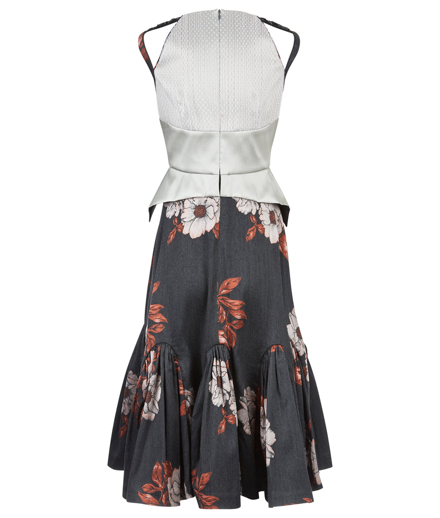 Sleevelss dress combination of ruched bust area with silver thin peplum aspect. Gathered flounces on lower dress adds volume and greater movement. Small gap in middle of bust. 600g approximate weight. 41% Polyester, 26% Acrylic, 26% Wool, 7% Polyamide. Contrast: 100% Nylon. Dry Clean Only. Made in England