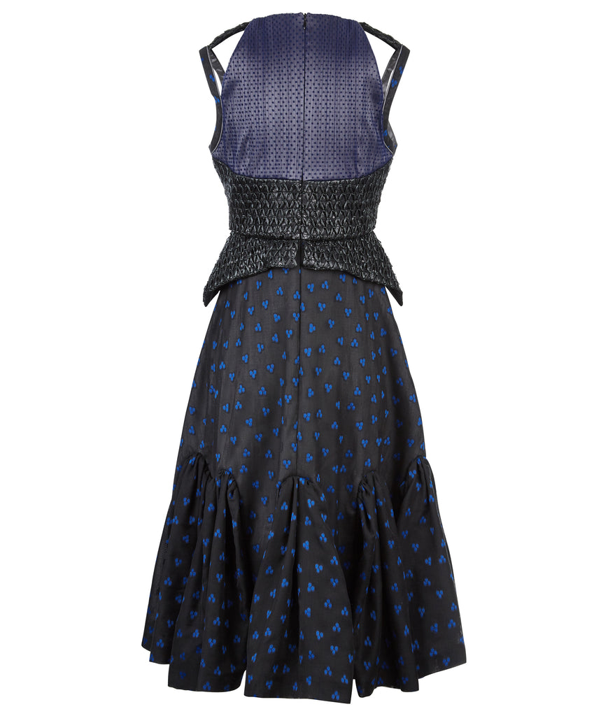 Sleevelss dress combination of blue ruched bust area with black faux leather thin peplum aspect and mid-waist panel. Gathered flounces on lower dress adds volume and greater movement. Small gap in middle of bust. 650g approximate weight. 81% Polyester, 14% Polyamide, 5% Elastine. Contrast 48% Polyester, 34% Cotton, 18% Nylon. Dry Clean Only. Made in England