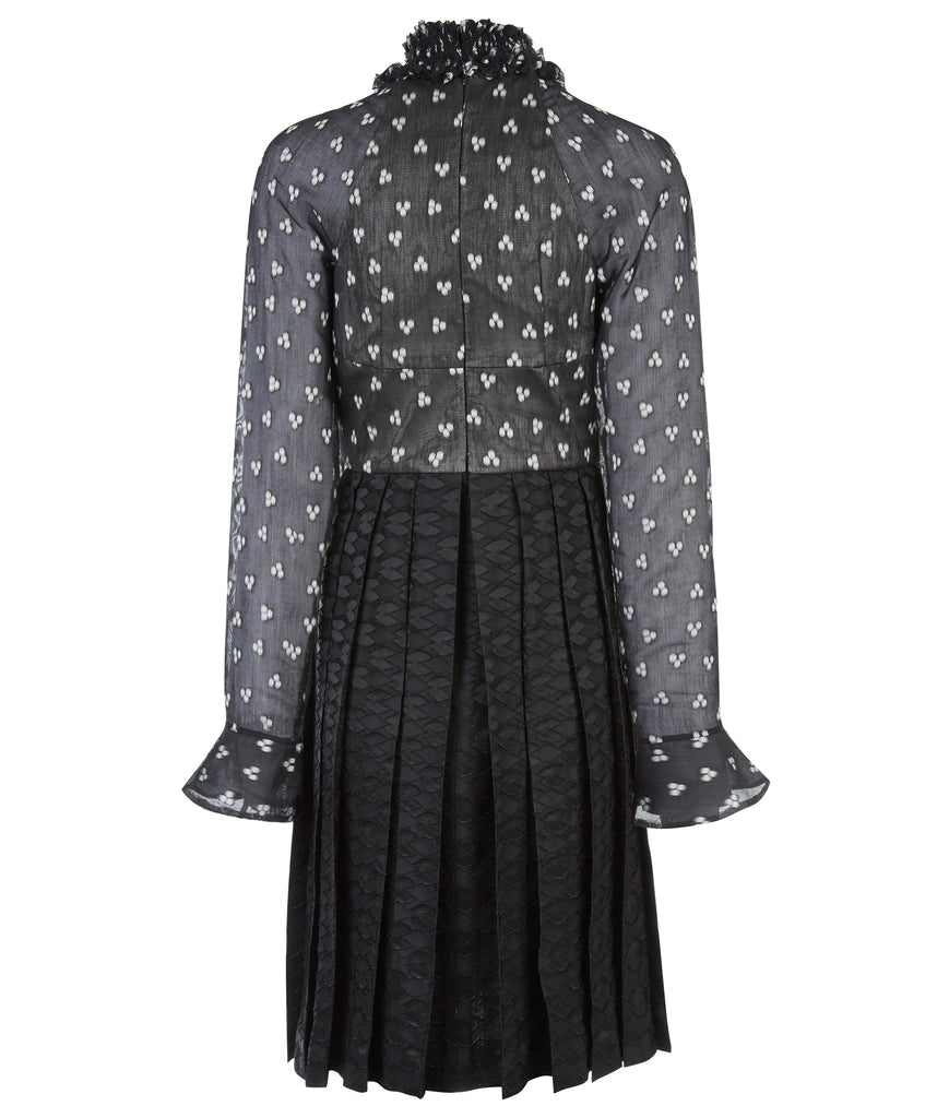 Medium length long sleeve dress featuring high ruched collar and gathered front bodice to waist panel. Sheer black with white tri-circular design. Slight fraying on collar natural part or ruching effect. Fully pleated below waist panel in solid black textured fabric. 700g approximate weight. 93% Acrylic, 7% Lycra. Contrast: 81% Polyester, 14% Polyamide, 5% Elastine. Dry Clean Only. Made in England