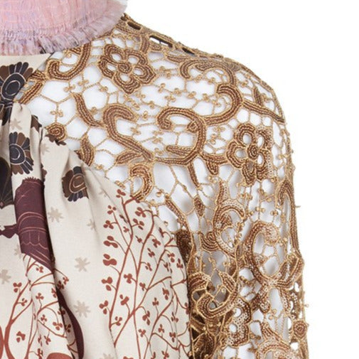 Print Tri-Point Dress. Sample sold as-is, no return, no refund. Contrast sequined and beaded gold lace contrast panels. Subtle floral print design on bodice. Full pleats below hip. CB invisible zipper. High ruched collar.