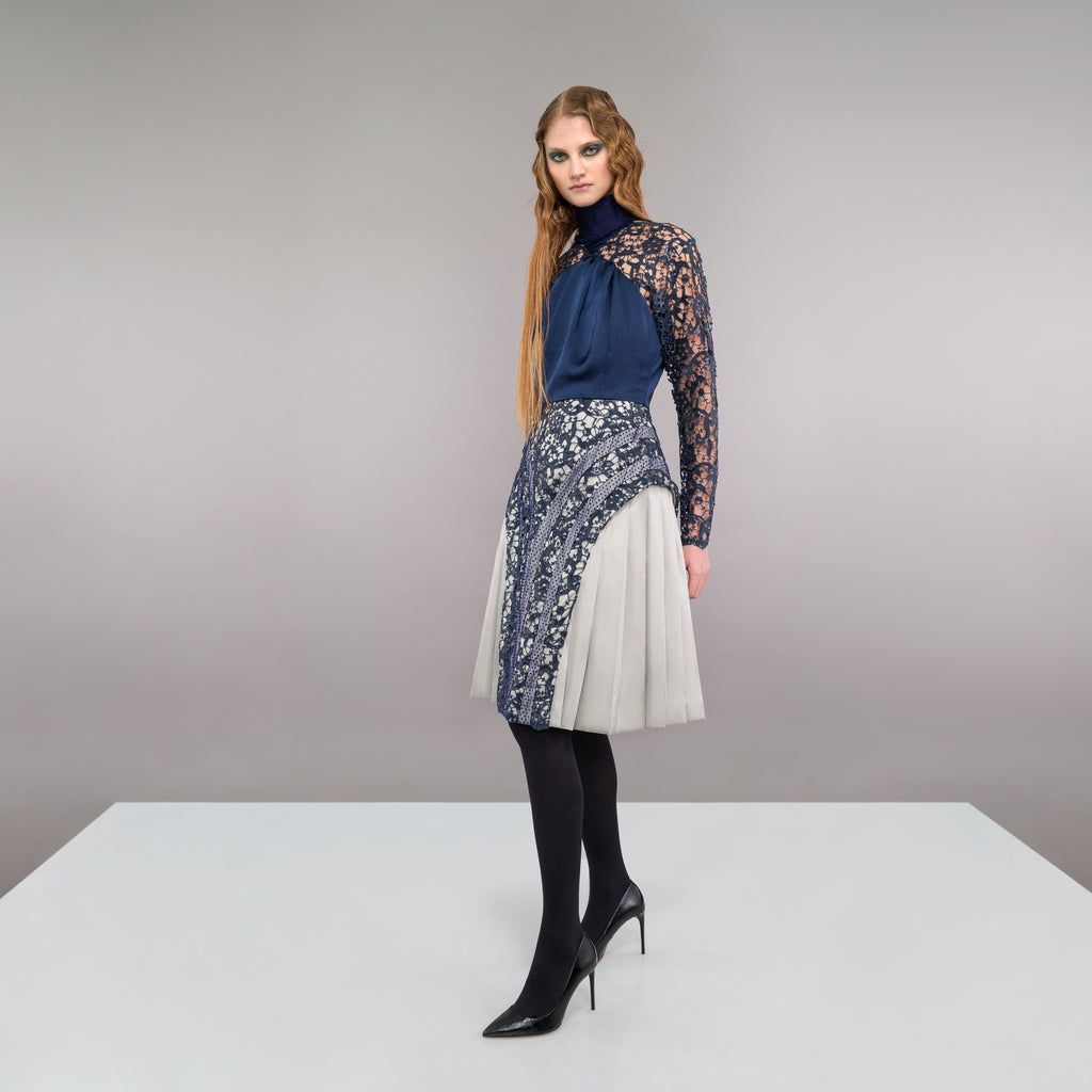 Elegant sequined lace dress in blue satin panel contrast and beige satin pleats. Ruched neckline with natural fraying effect. CB invisible zipper. 1.1kg approximage weight. 100% Polyester. Contrast: 81% Polyester, 14% Polyamide, 5% Elastine Dry Clean Only. Made in England