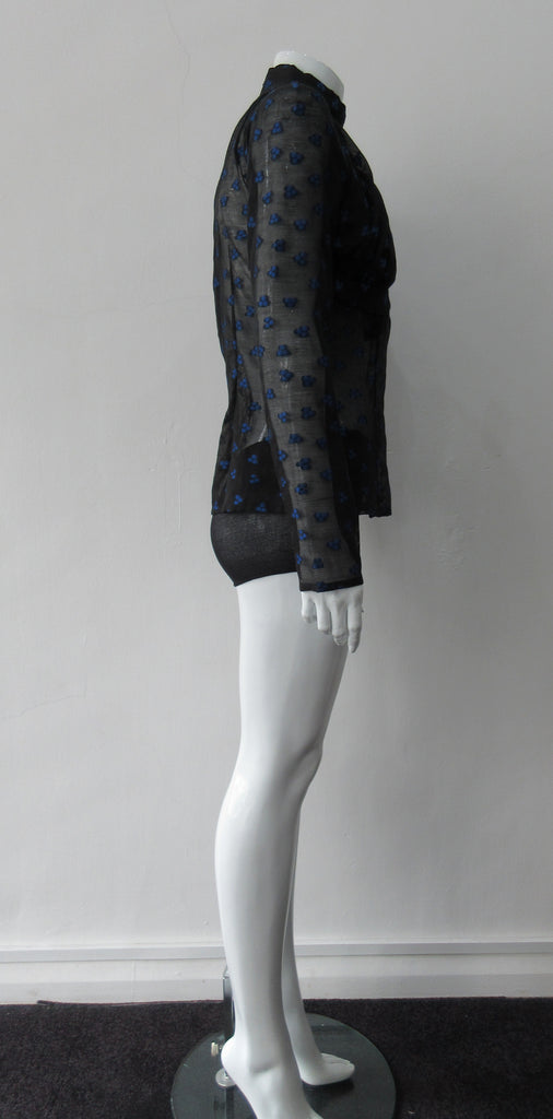 Dark Gathered Top, Generously gathered long sleve top in sheer black with tri-blue dot design. CB zipper and under bust panel trim. 2 invisible side zippers at side seam bottom. Can be paired with 180608D Dark Curve Front Pencil Skirt, CB length 60cm. 50g approximate weight 48% Polyester, 34% Cotton, 18% Nylon. Dry Clean Only. Made in England