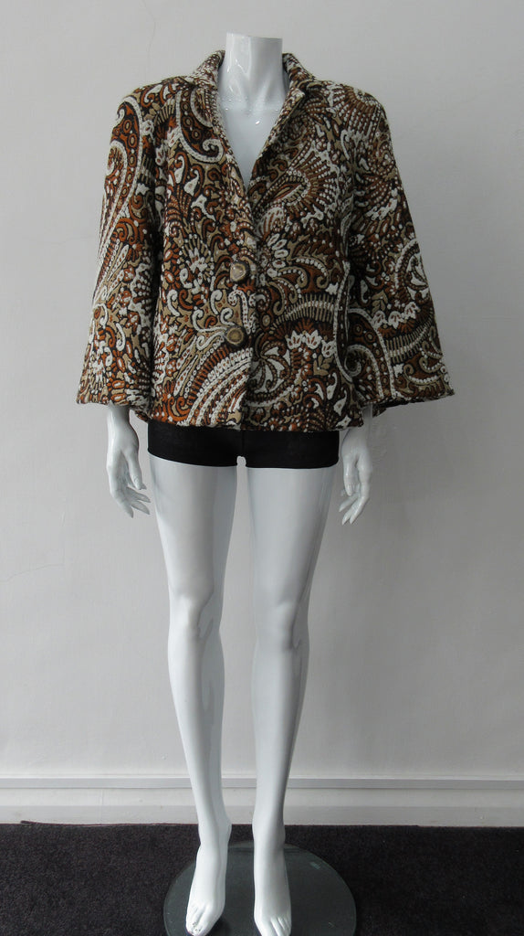 Duster Mini Swing Jacket. Cropped full swing brown, brass and beige multi textured brocade jacket. Including 2 beautiful buttons. CB length 55cm. 1.2kg approximate weight. 71% Wool, 12% Cotton, 10% Acetate, 7% Polyamide. Lining 100% Rayon. Dry Clean Only. Made in England