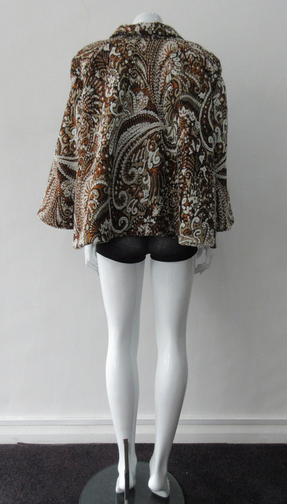 Duster Mini Swing Jacket. Cropped full swing brown, brass and beige multi textured brocade jacket. Including 2 beautiful buttons. CB length 55cm. 1.2kg approximate weight. 71% Wool, 12% Cotton, 10% Acetate, 7% Polyamide. Lining 100% Rayon. Dry Clean Only. Made in England