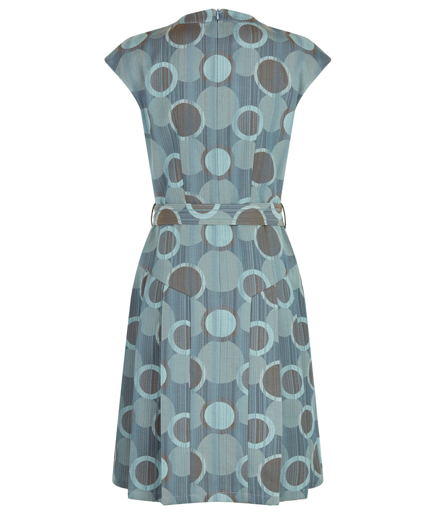 Spot Pleat Dress. Elegant sleevelss dress in multi seagreen circle design in the wovn fabric. Cirular cut away below neck on front of dress with attached collar. Side pleats below hip for ease of movement. Belt and silver buckle. Collar height 3cm. CB length from neck point 97cm. 150g approximate weight. 60% Cotton, 40% Polyester. Dry Clean Only.Made in England