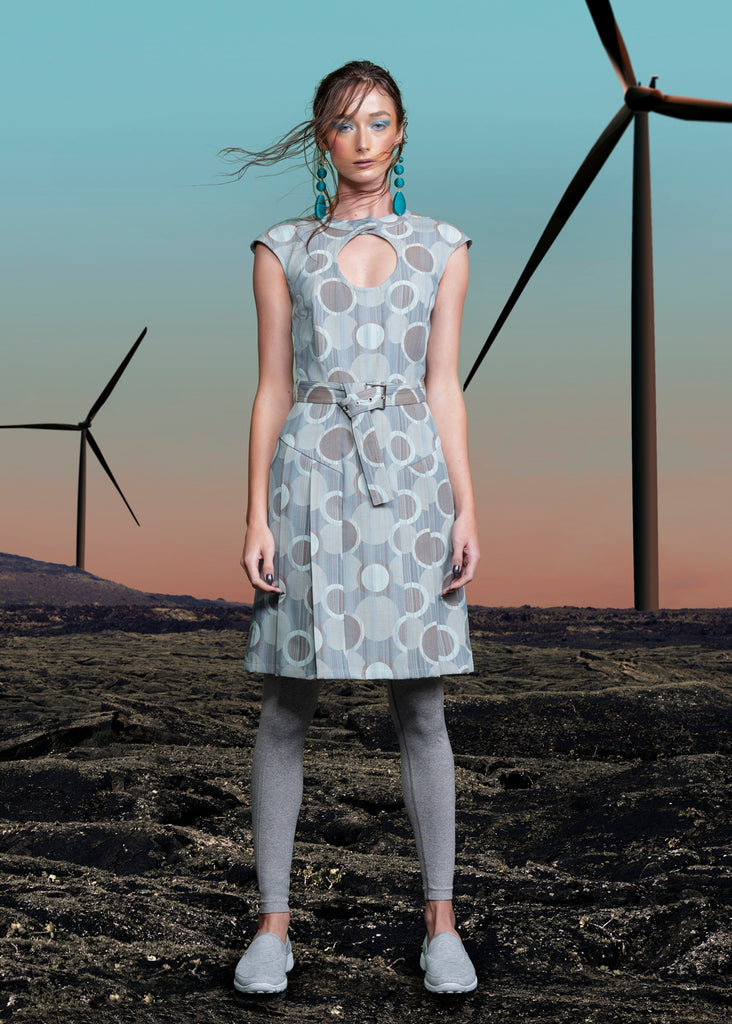 Spot Pleat Dress. Elegant sleevelss dress in multi seagreen circle design in the wovn fabric. Cirular cut away below neck on front of dress with attached collar. Side pleats below hip for ease of movement. Belt and silver buckle. Collar height 3cm. CB length from neck point 97cm. 150g approximate weight. 60% Cotton, 40% Polyester. Dry Clean Only.Made in England