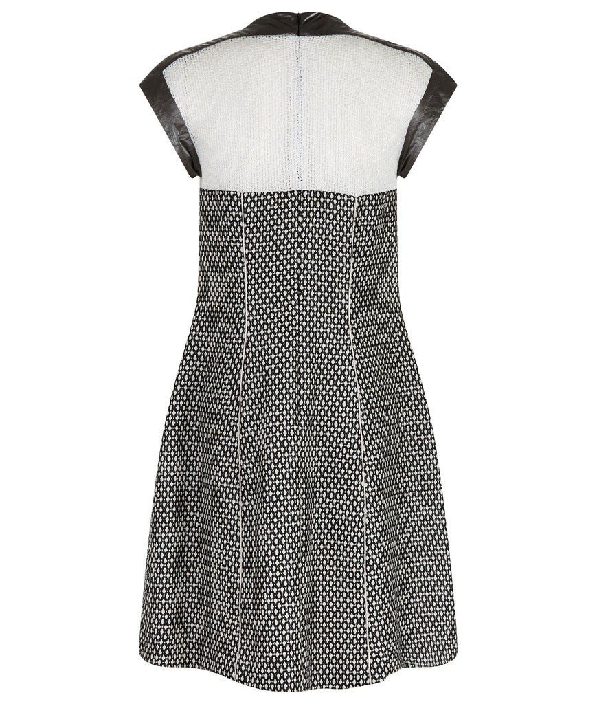 Swing Dress. Mixed array of black & white cross tooth with sheer chunky knit upper bodice, and grey Tyvek shoulder & arm panel. Contrast piping on front & back seams. CB length from neckpoint 96cm. 110g approximate weight. 86% Cotton, 14% Nylon. Contrast: 100% Acrylic. Lining: 100% Rayon. Dry Clean Only.Made in England