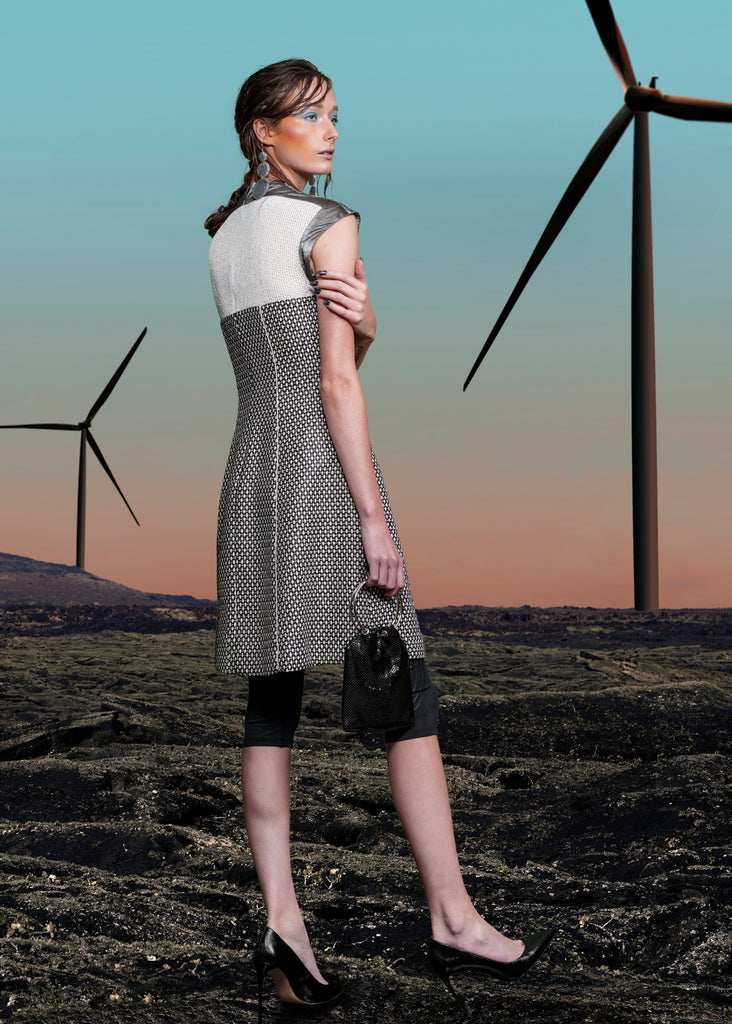 Swing Dress. Mixed array of black & white cross tooth with sheer chunky knit upper bodice, and grey Tyvek shoulder & arm panel. Contrast piping on front & back seams. CB length from neckpoint 96cm. 110g approximate weight. 86% Cotton, 14% Nylon. Contrast: 100% Acrylic. Lining: 100% Rayon. Dry Clean Only.Made in England