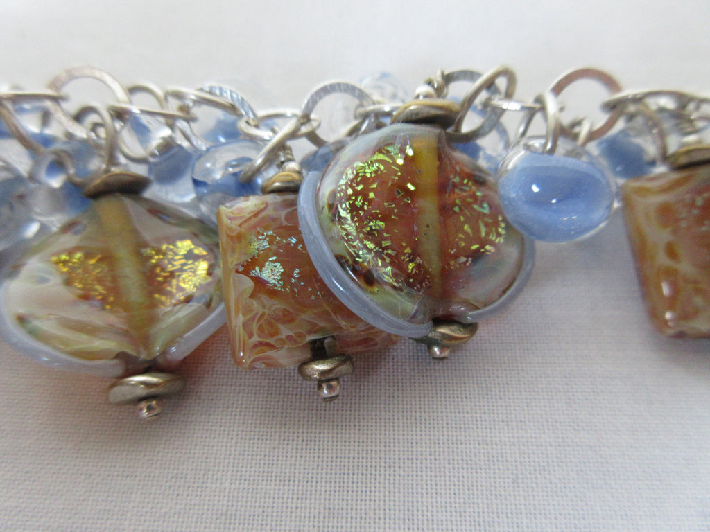 Resin cats eye bracelet square and circle resin light blue accent circular steel loops close-up zoom image photo picture