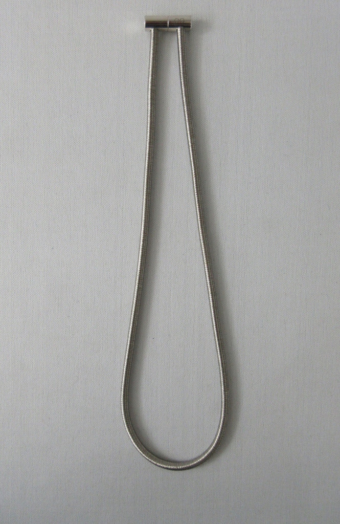 Metallic silver colour bracelet with magnetic tips for attachment/seperation. Metal unknown, probably stainless steel. 50.5cm full length, 23cm length when worn