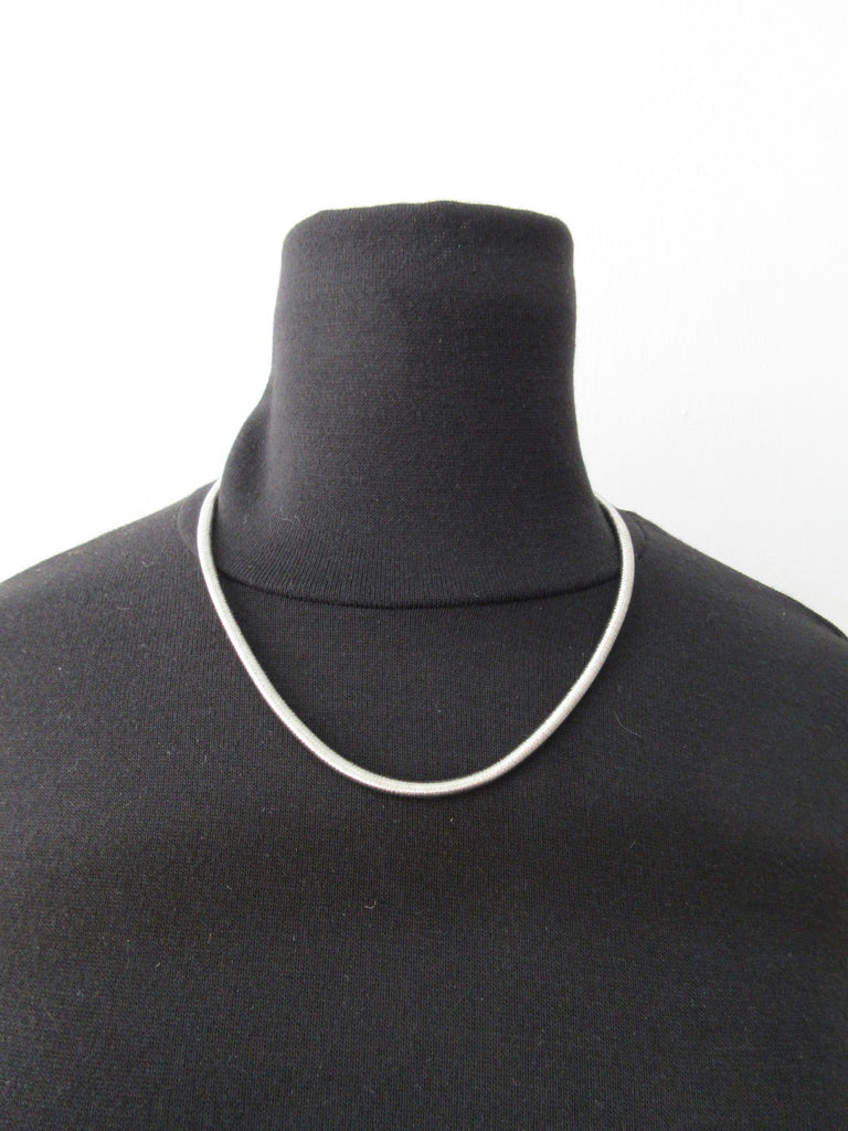 Metallic silver colour bracelet with magnetic tips for attachment/seperation. Metal unknown, probably stainless steel. 50.5cm full length, 23cm length when worn