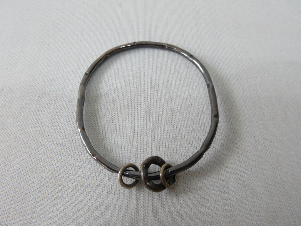 Karyn Chopik Dented Dark Silver Bracelet with 3 Small Rings, Sterling Silver, Antiquated Brass & Copper, Size: 1 Medium -6.5cm inside diameter. 35 grams approximate weight, Made in Canada